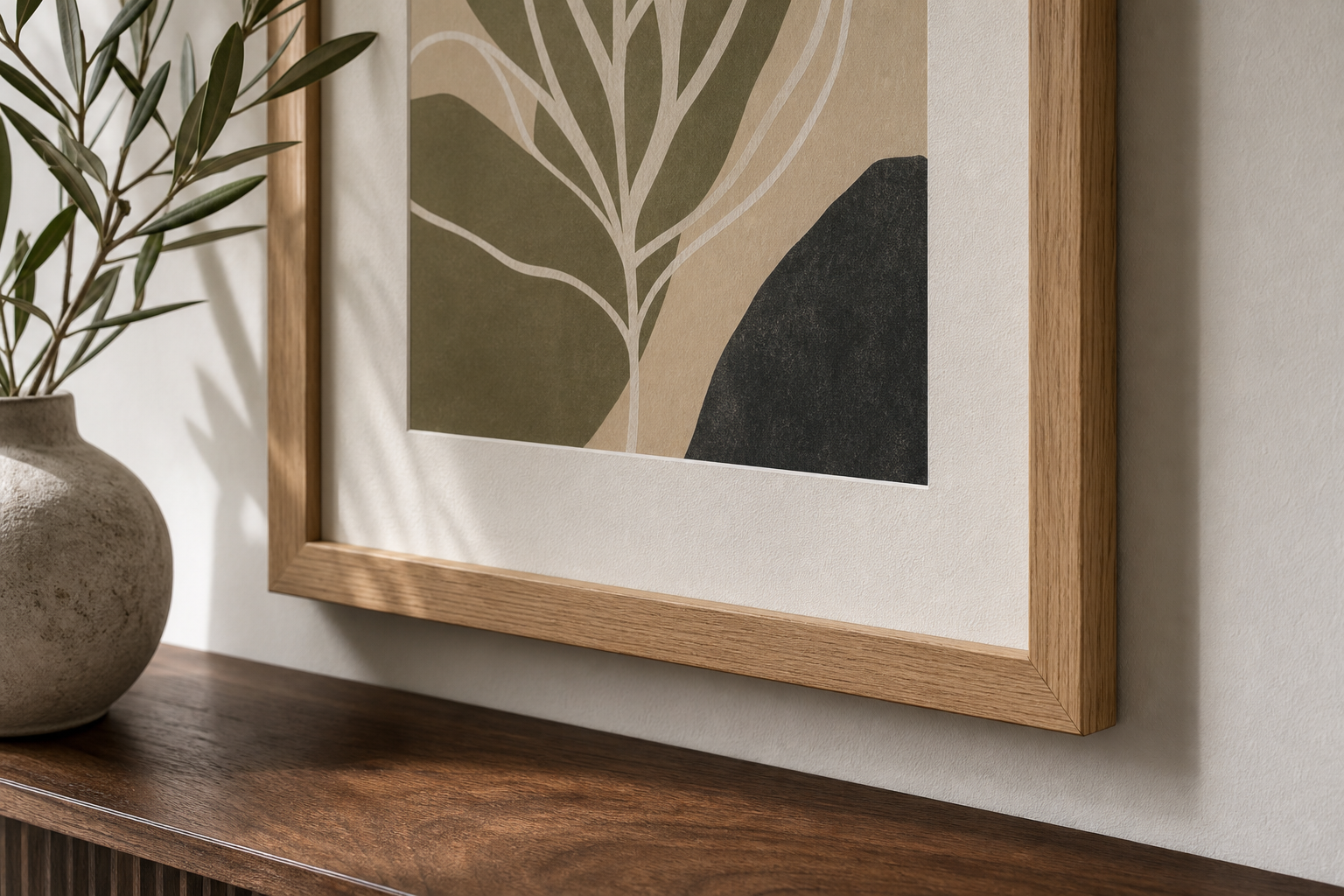 Close-up of framed abstract wall art with oak frame