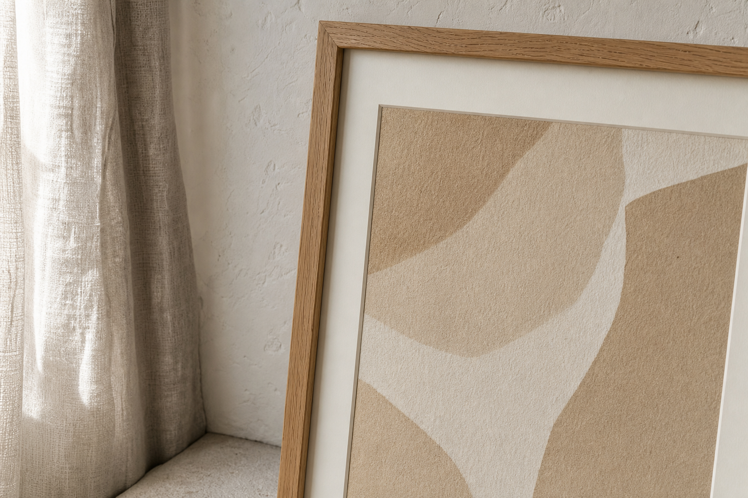 Close-up of beige textured wall art in an oak frame with mat