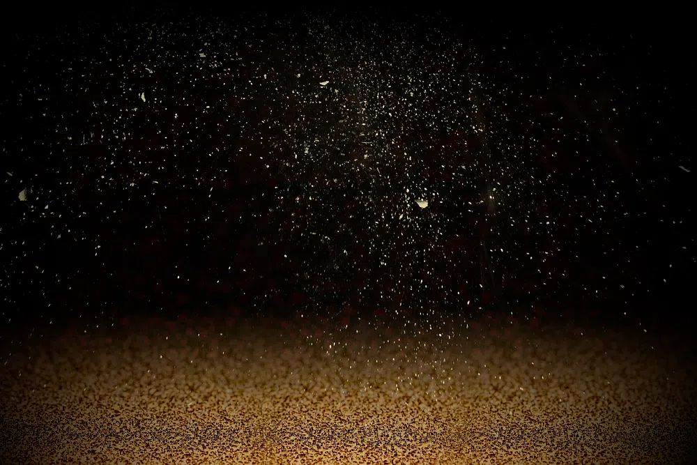 Gold confetti on dark background. poster detail