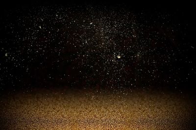 Gold confetti on dark background. poster print