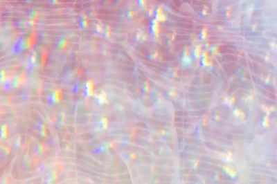 Sparkly pink holographic textured background.