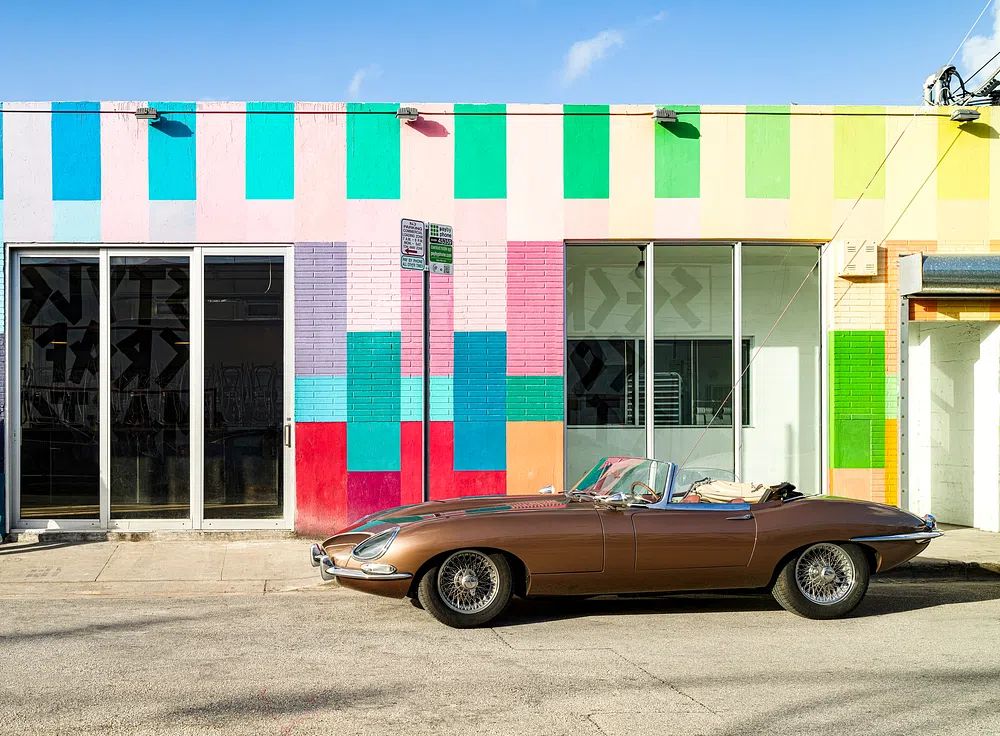Classic Car Against Colorful Wall Poster. poster detail