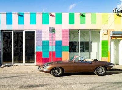 Classic Car Against Colorful Wall Poster. poster