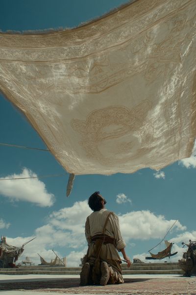 Kneeling Figure Under Canopy — Cinematic Print. poster print