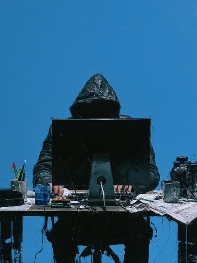 Hooded Figure at Desk — Contemporary Print.