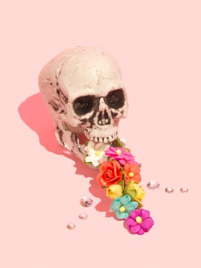 Skull vomiting colorful flowers.