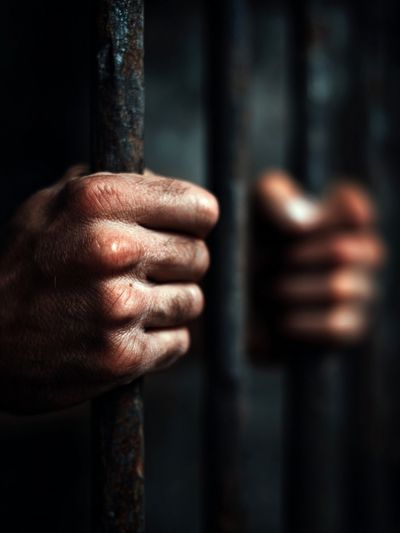 Hands Gripping Prison Bars — Photography Print. poster