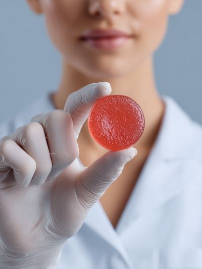 Lab Technician Holding Red Candy Poster. poster print