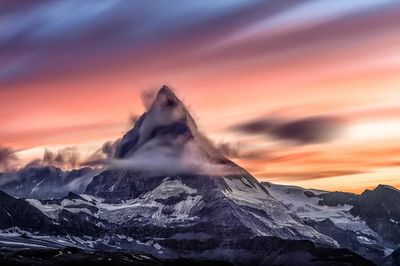 Snowcapped mountain peak cloudy sunrise. poster print