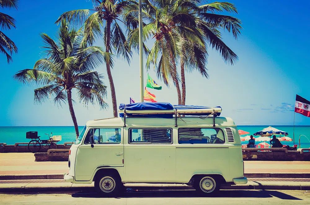Classic caravan parked front beach. poster detail