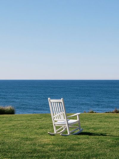 Oceanfront Rocking Chair Photography Poster. poster
