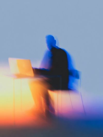 Blurred Figure at Laptop Photography Poster. poster print