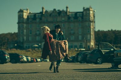 Cinematic Couple in Front of Manor Poster. poster