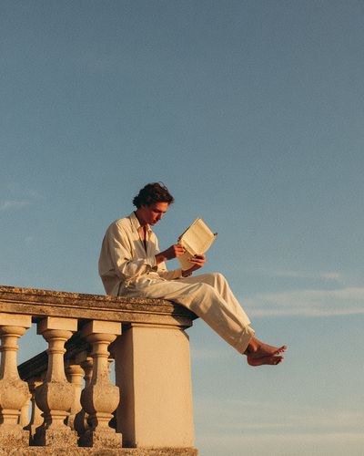 Sunlit Reader on Terrace Photography Poster. poster