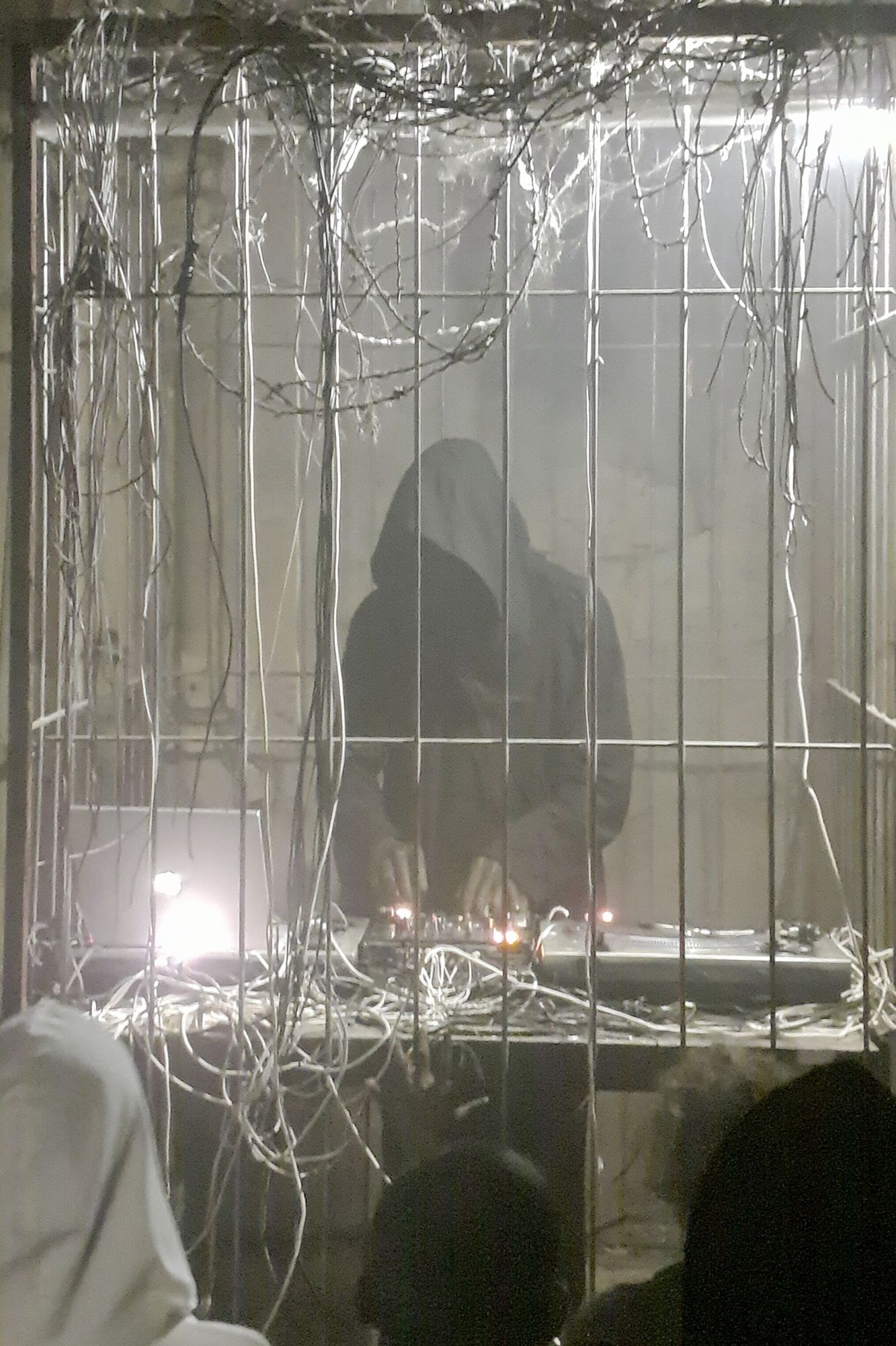 Hooded Figure in Wire Cage Poster. poster — photography art