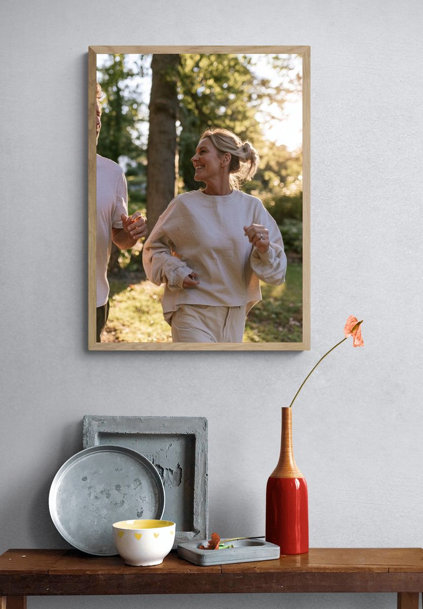 Couple Jogging in Sunlit Forest Photography Poster. — room view 3