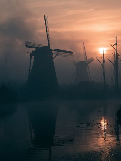 Misty Windmills at Sunset Poster.