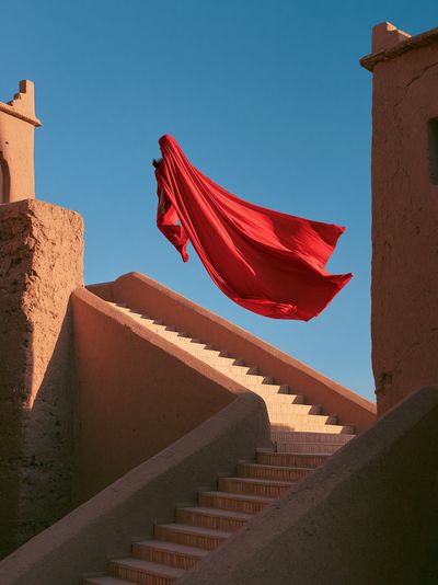 Red Cloak Stairway Photography Poster. poster