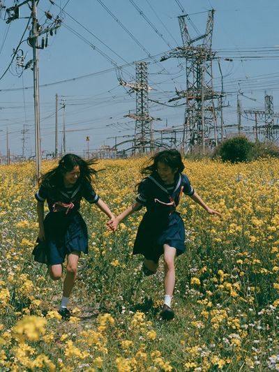 Girls Running Through Wildflowers Poster.