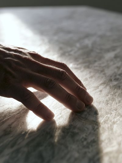 Hand on Marble Surface Photography Poster.