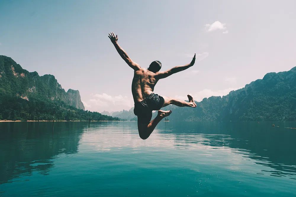 Man jumping joy lake. poster detail