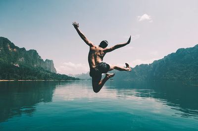 Man jumping joy lake. poster print