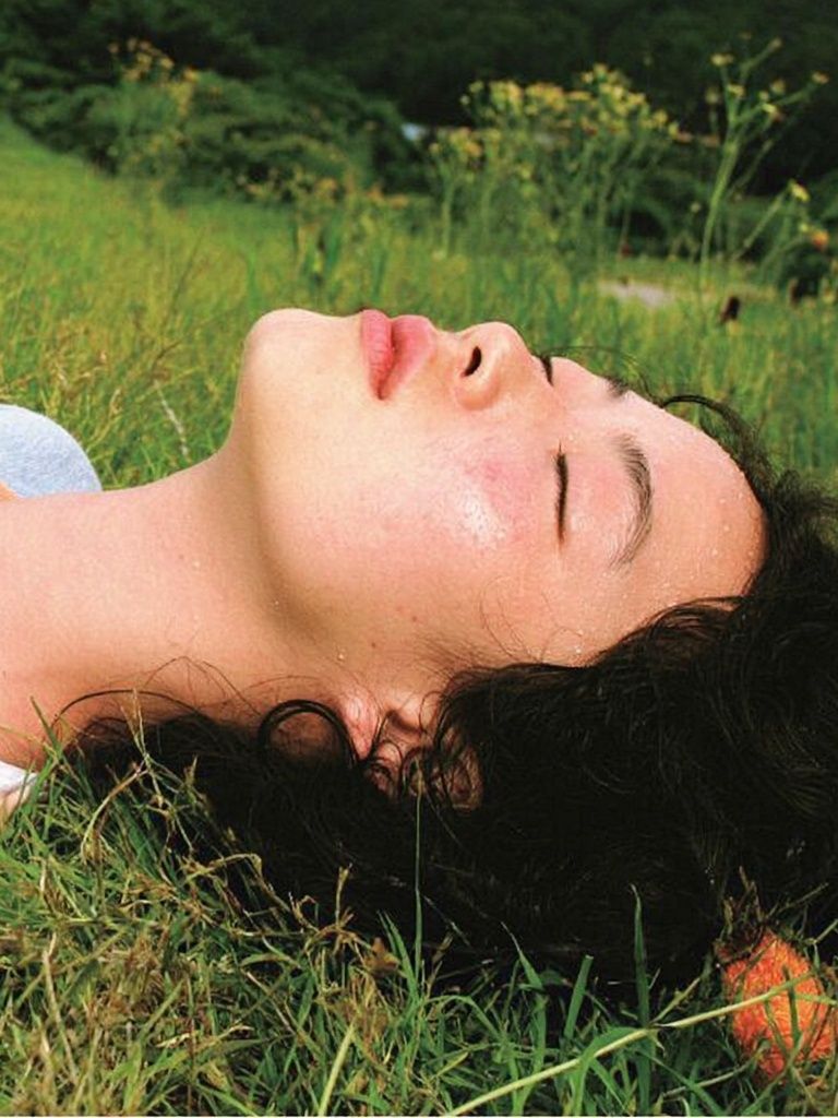 Woman Resting in Grass Photography Poster. poster detail
