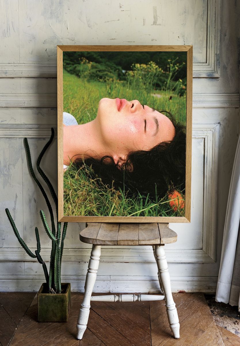 Woman Resting in Grass Photography Poster. — room view 1