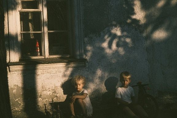 Children in Sunlit Courtyard Photography Poster. poster — photography art