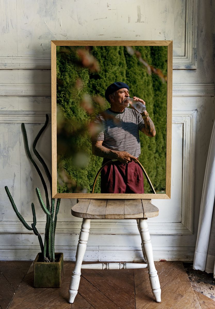 Man in Beret Drinking Water Poster. — room view 1