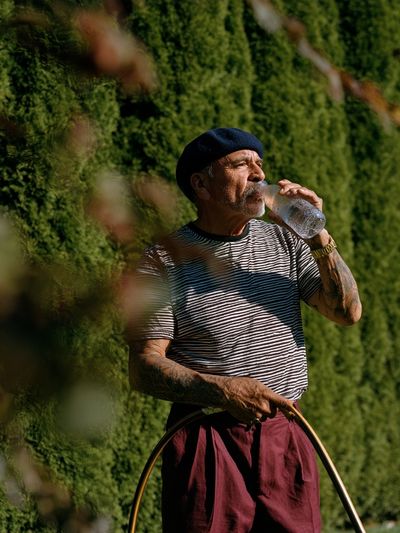 Man in Beret Drinking Water Poster. poster