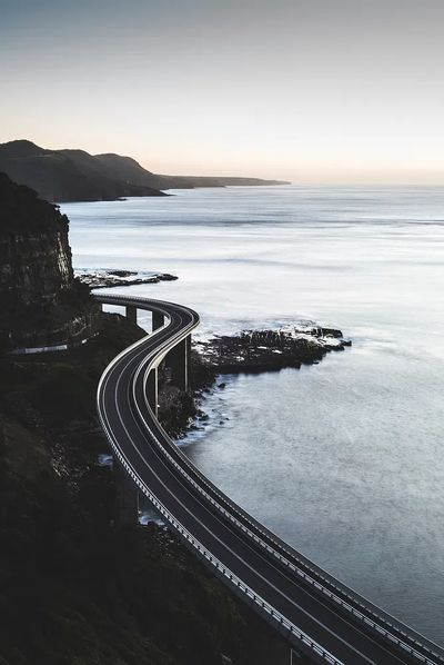 long elevated road along seashore. poster