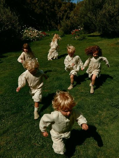 Children Running in Garden Photography Poster. poster print