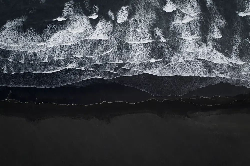 Aerial view black sand beach. poster detail