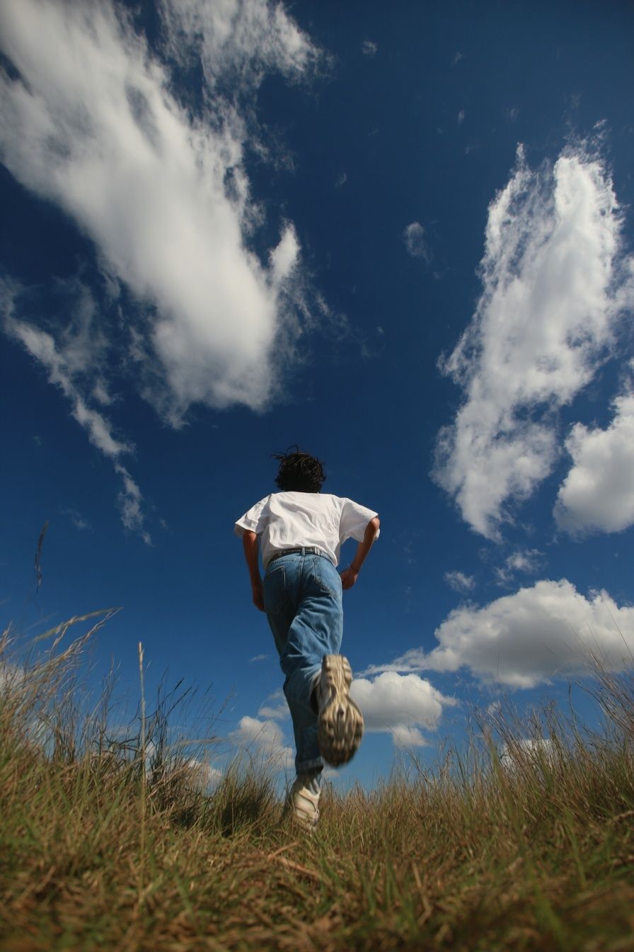 Runner Under Blue Sky Photography Poster. poster detail