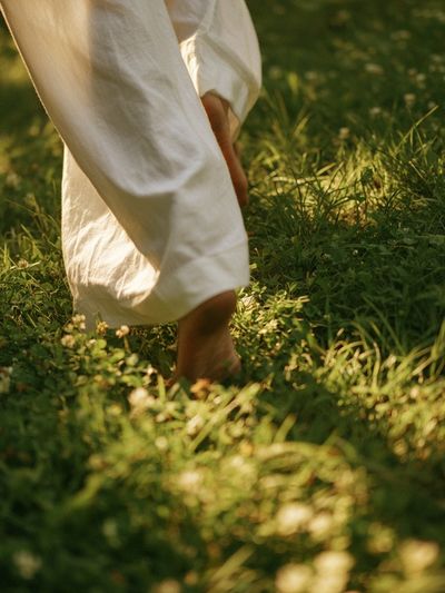 Barefoot Walk in Sunlit Grass Photography Poster. poster