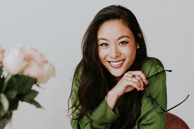 Beautiful cheerful Asian woman sitting. poster print