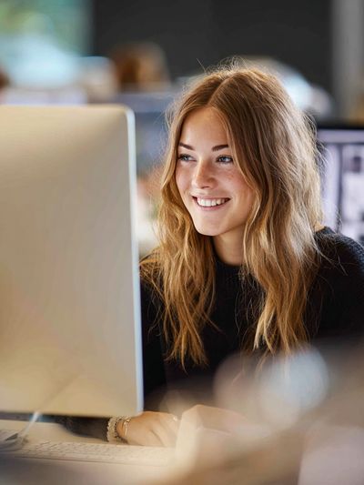Smiling Woman at Desk Photography Poster. poster print