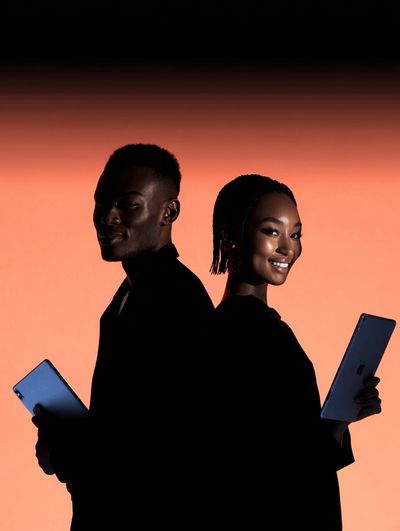 Silhouetted Couple with Tablets — Photography Print. poster