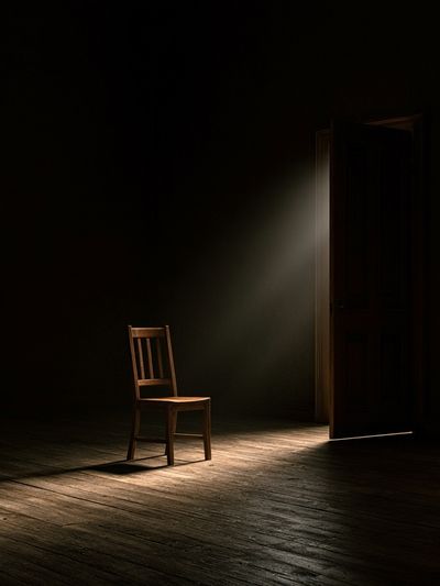 Lonely Chair in Dark Room Poster. poster