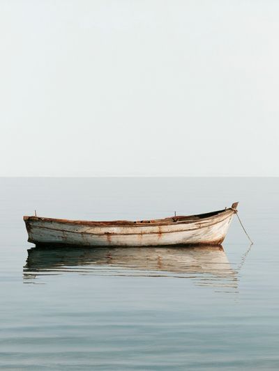 Solitary Boat by the Sea Poster.