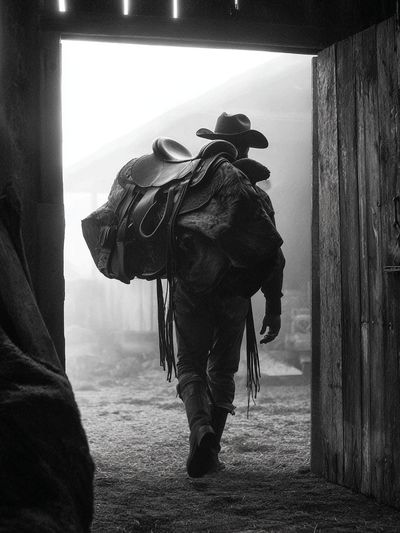 Cowboy in Barn Doorway Black-White Poster. poster print