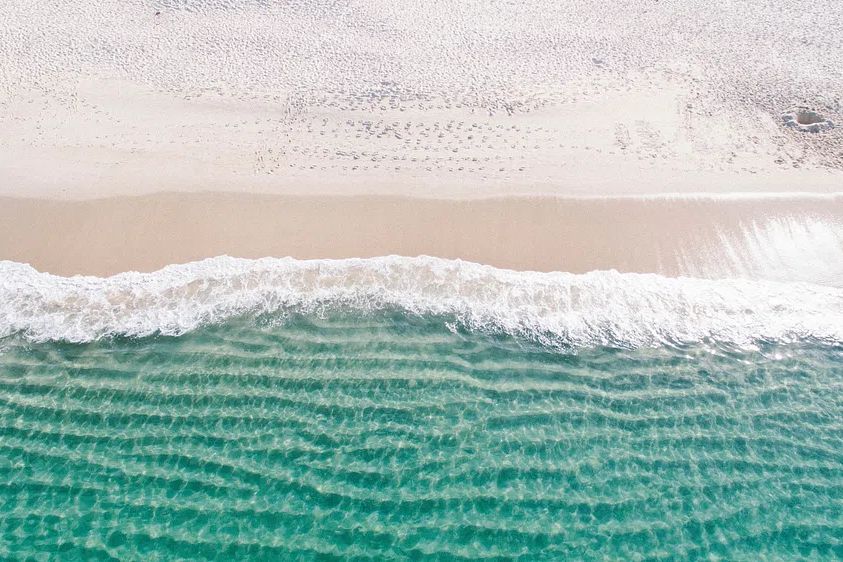 Drone view ocean waves washing. poster detail