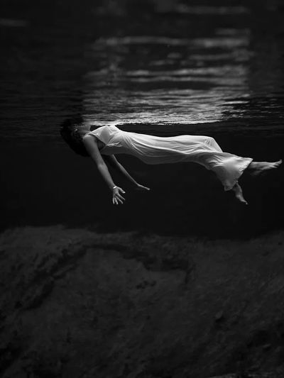 Underwater view woman, wearing long. poster print