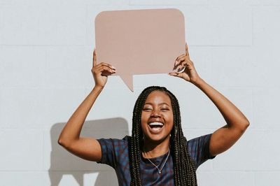 Cheerful black woman showing blank. poster print