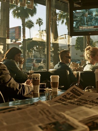 Sunlit Coffee Shop Scene Photography Poster. poster