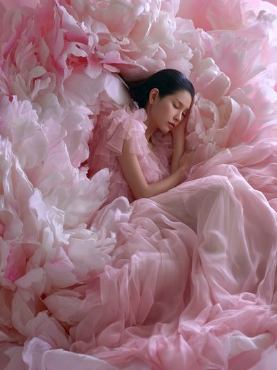 Sleeping Woman in Pink Petals Poster. poster