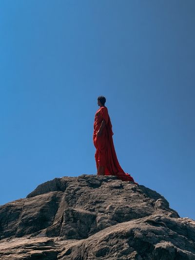 Red Figure on Rock Photography Poster.
