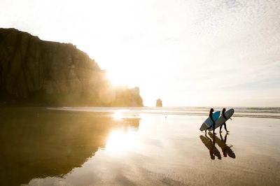 Surfers at Sunset — Photography Print. poster