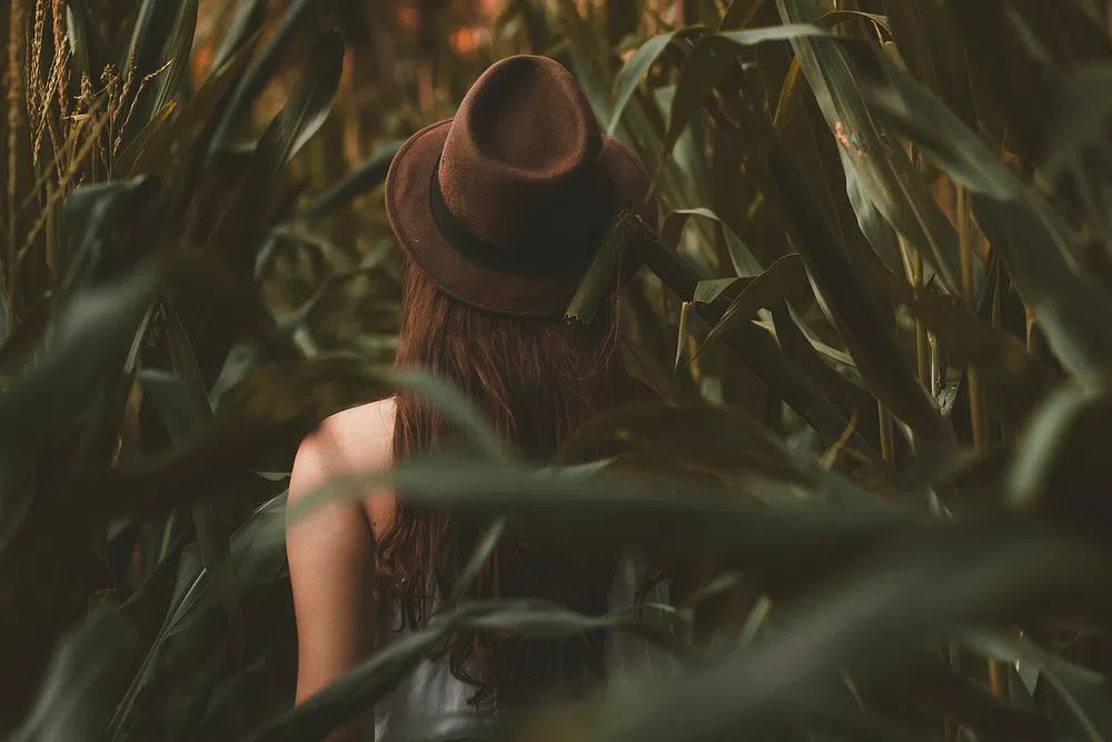 girl wearing brown hat walking. poster — photography art